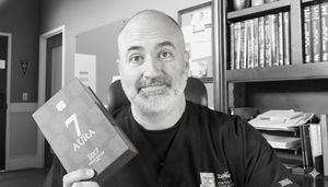 Dr. John Zannis holding a box of SIX7 olfactory neurodesigned fragrance