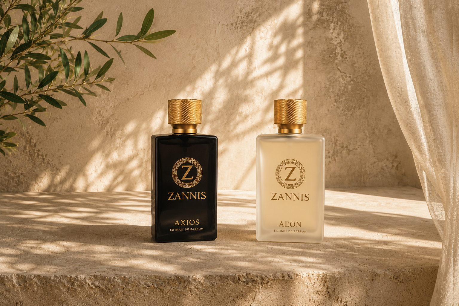 Two Zannis perfume bottles on a stone ledge in warm sunlight, one black with gold detailing and one frosted white with gold detailing, with olive branches and a sheer curtain in the background.